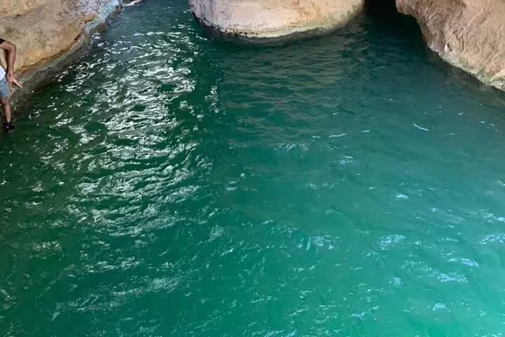 Explore the serene turquoise waters of a hidden canyon on the Ras Al Hadd overnight camping tour.