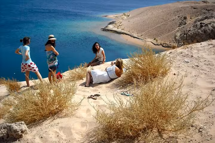 Tourists relaxing on a cliff above the Red Sea in Ras Mohamed National Park, Sharm El-Sheikh tour