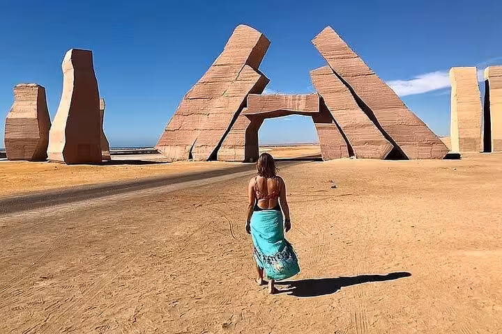 Visitor walking to Ras Mohammed Gate rocks landmark, photo stop on half-day bus tour from Sharm El Sheikh