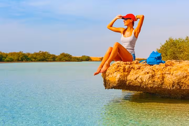 Traveler relaxing by Ras Mohammed National Park lagoon on half-day bus tour from Sharm El Sheikh