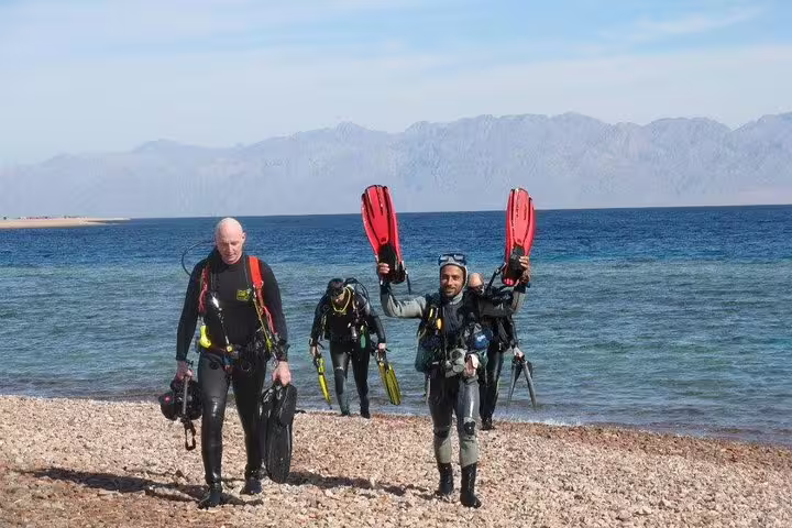 Divers exiting the Red Sea at Ras Mohammed National Park, part of a private snorkeling and day tour from Sharm