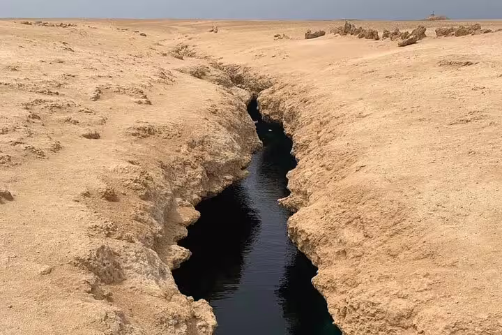 Narrow sea fissure through Ras Mohammed desert coastline, scenic stop on Sharm El Sheikh half-day bus tour