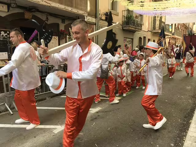 Festive parade in Raval Quarter, Barcelona, showcasing vibrant costumes and local culture on a private walking tour.