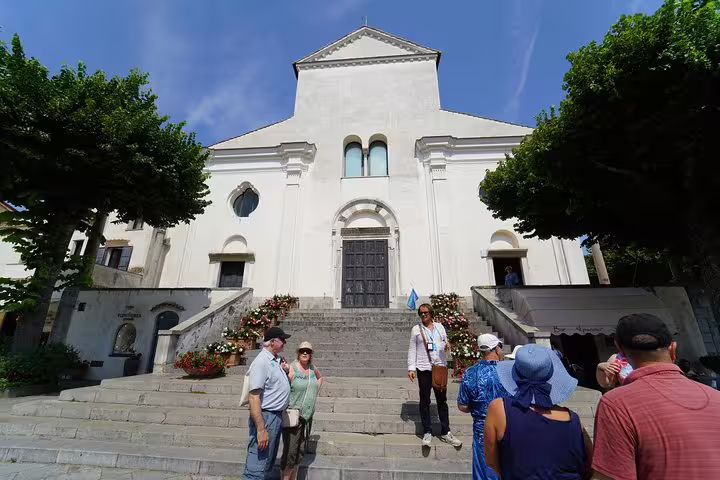 Visitors admire the historic architecture of a cathedral in Ravello on the Amalfi Coast tour.