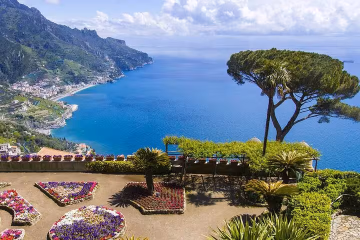 Scenic view of Ravello gardens overlooking Amalfi Coast's azure waters on a small group tour from Sorrento.