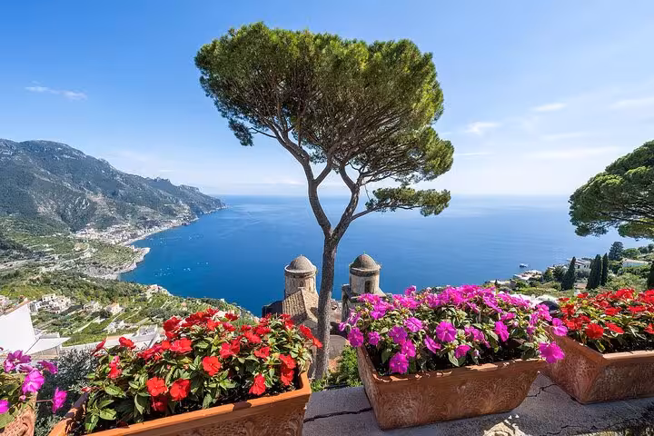 Vibrant flowers and panoramic sea views from a scenic terrace in Ravello, Italy, on a half-day tour.