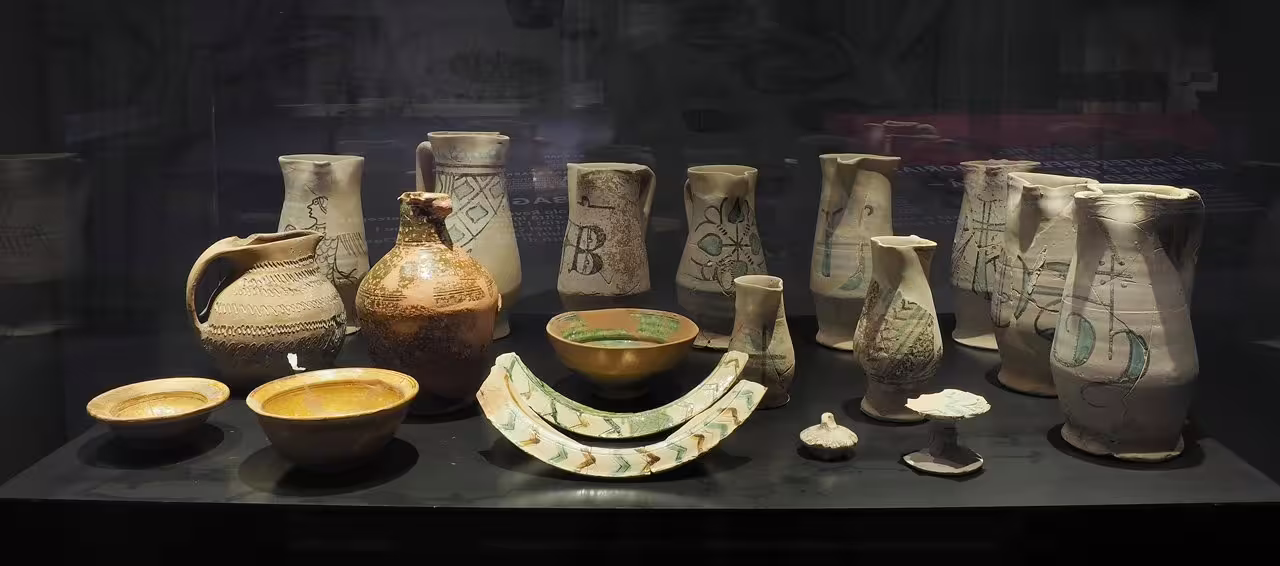 Medieval ceramic jugs and bowls in a display case at Ravenna Classis Museum, included with entry ticket