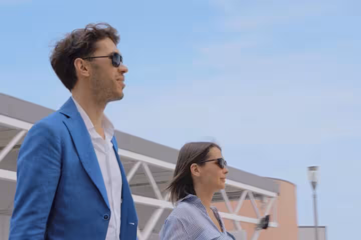 Stylish travelers at Ravenna Cruise Terminal ready for their transfer to Venice under clear blue skies.