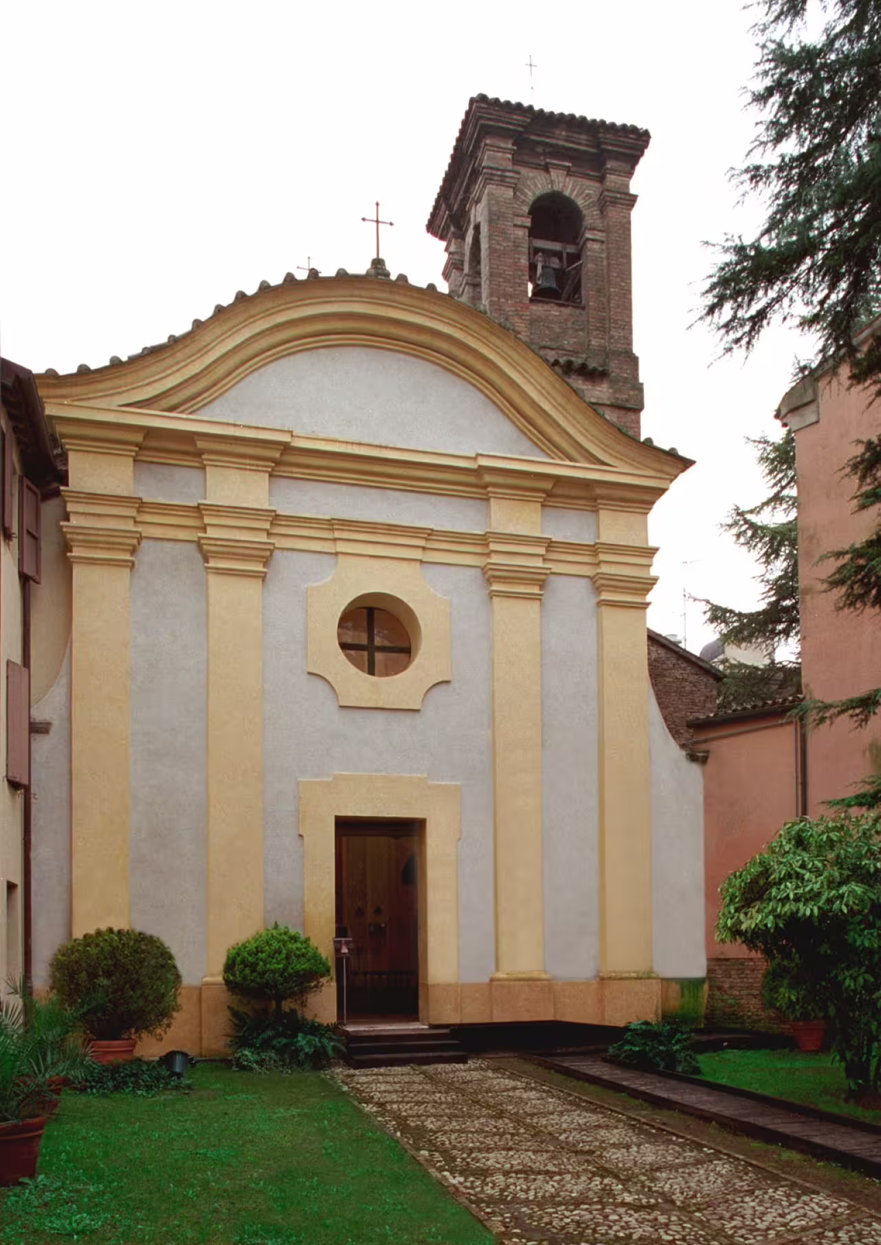 Entrance of Ravenna’s Domus Tappeti di Pietra archaeological site near church facade, Italy tour stop
