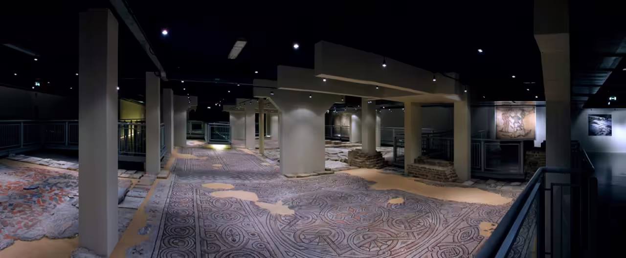 Interior of Domus Tappeti di Pietra in Ravenna showcasing ancient Roman mosaic floors on guided visit