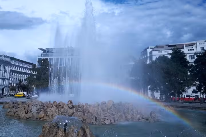Vienna fountain with rainbow spray, scenic photo stop on RAXI e-rickshaw big private Vienna tour