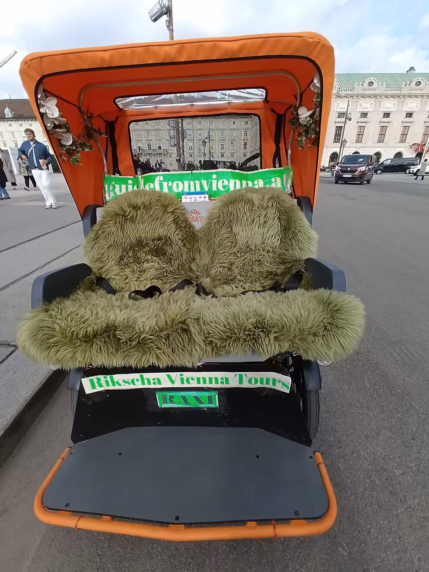 RAXI panoramic electric rickshaw in Vienna with warm fur blankets, comfortable eco-friendly city tour ride