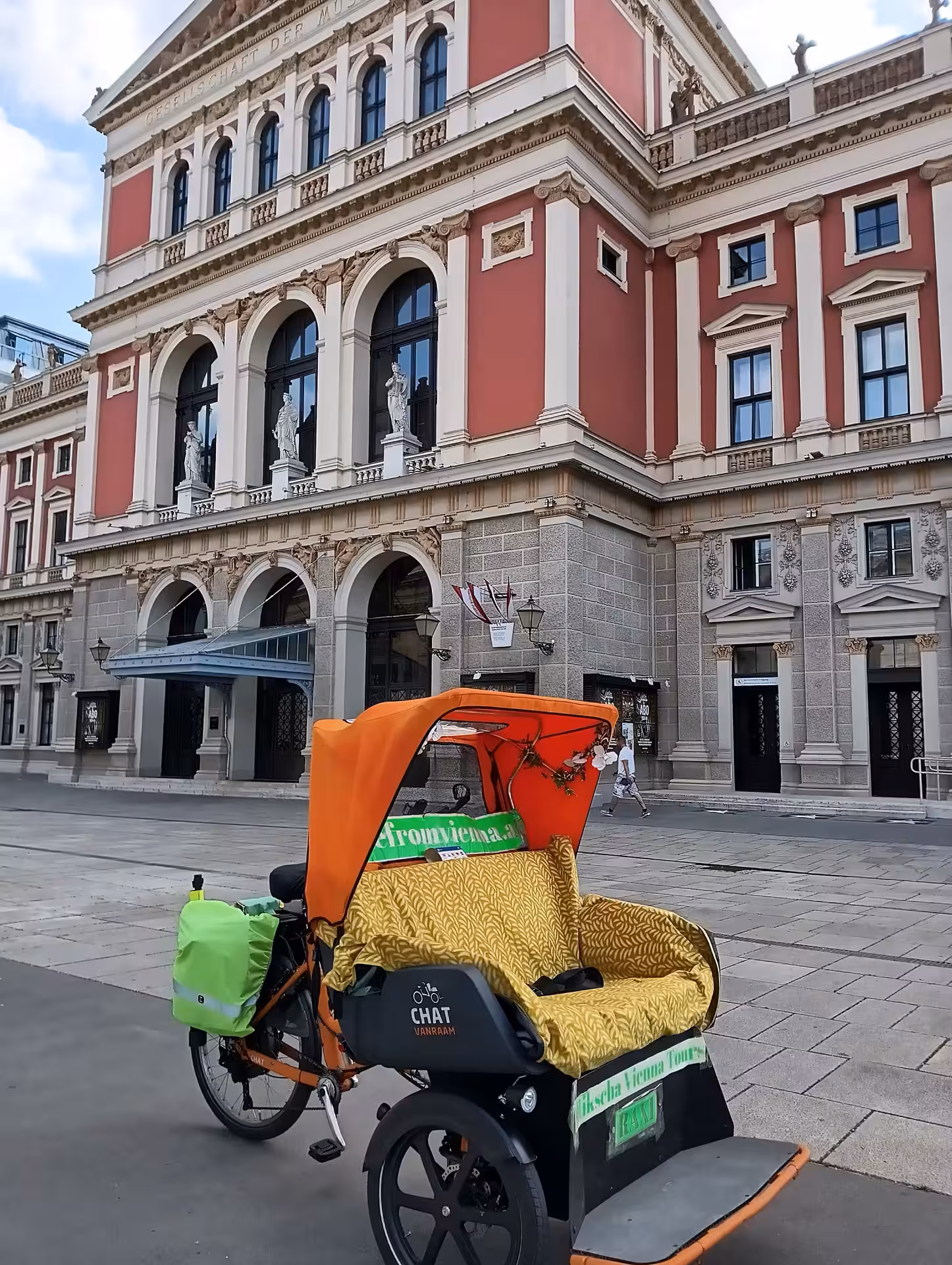 RAXI electric rickshaw parked by historic Vienna architecture, perfect for an exclusive panoramic sightseeing ride
