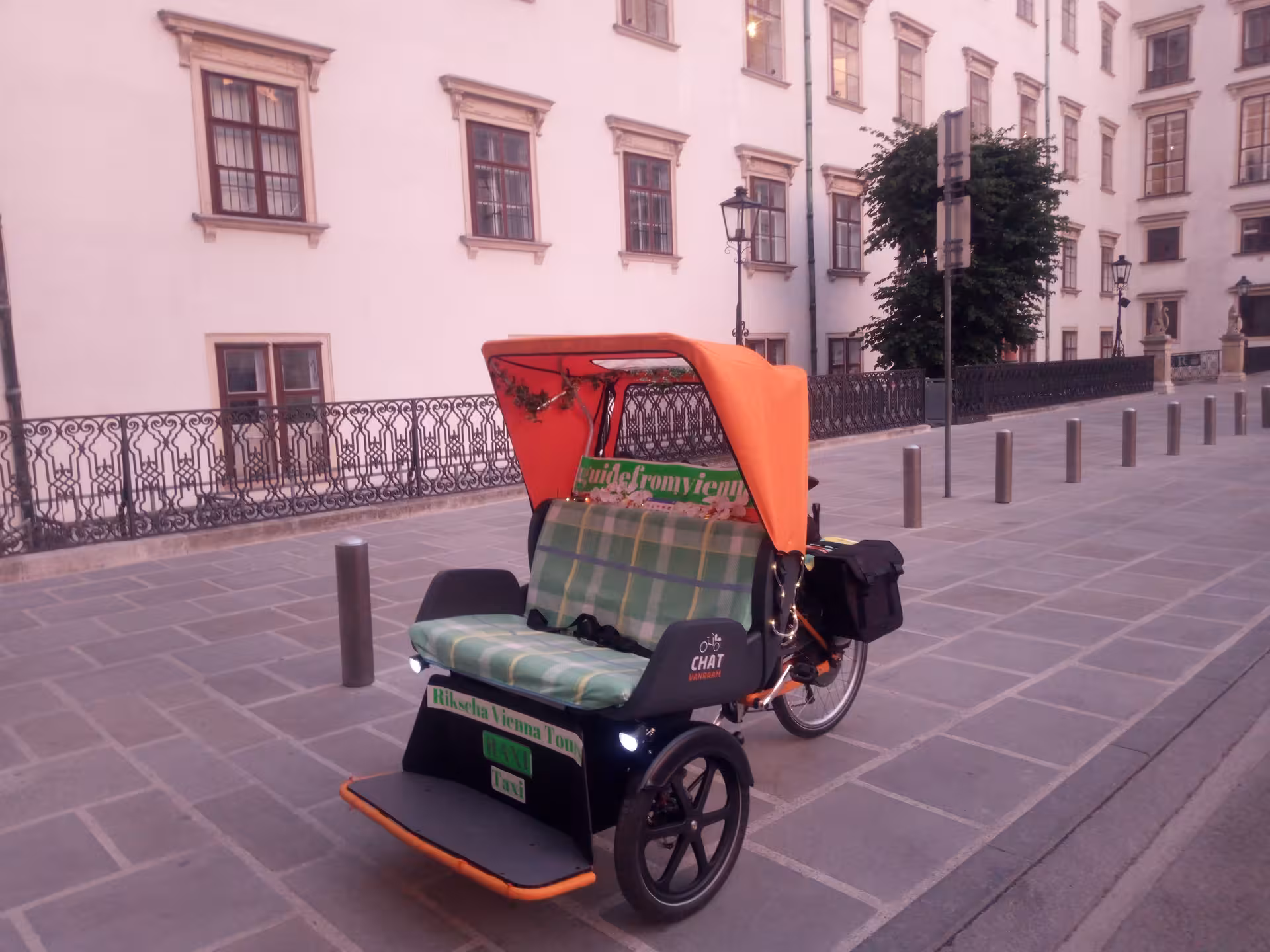 RAXI electric rickshaw parked in Vienna old town street, ready for a private panoramic sightseeing ride