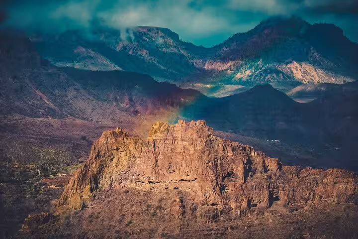 Close-up of a dramatic rock formation in the Red Canyon with shadowed mountains in the background.