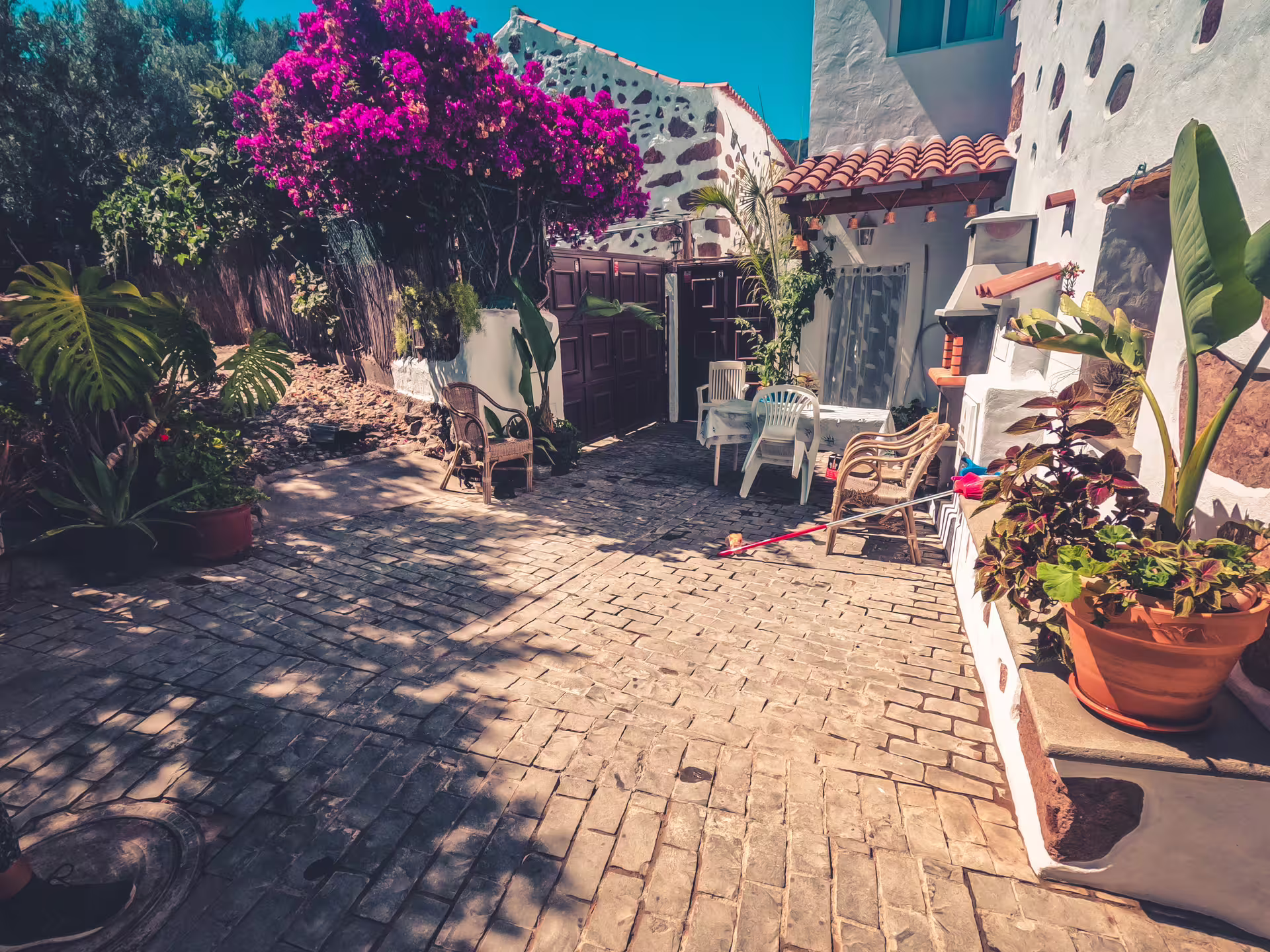 Charming courtyard with vibrant flowers and rustic decor on the Red Canyon Tour, perfect for a small group experience.