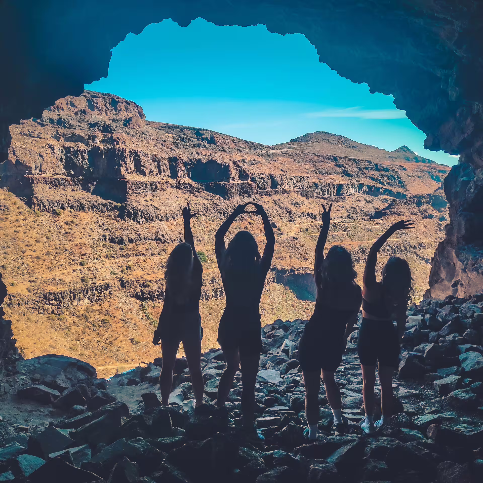 Silhouettes of a joyful group against the stunning Red Canyon landscape, highlighting the tour's scenic beauty.