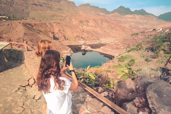 Tourists capturing the breathtaking views of Red Canyon's picturesque landscapes during a guided small group tour.