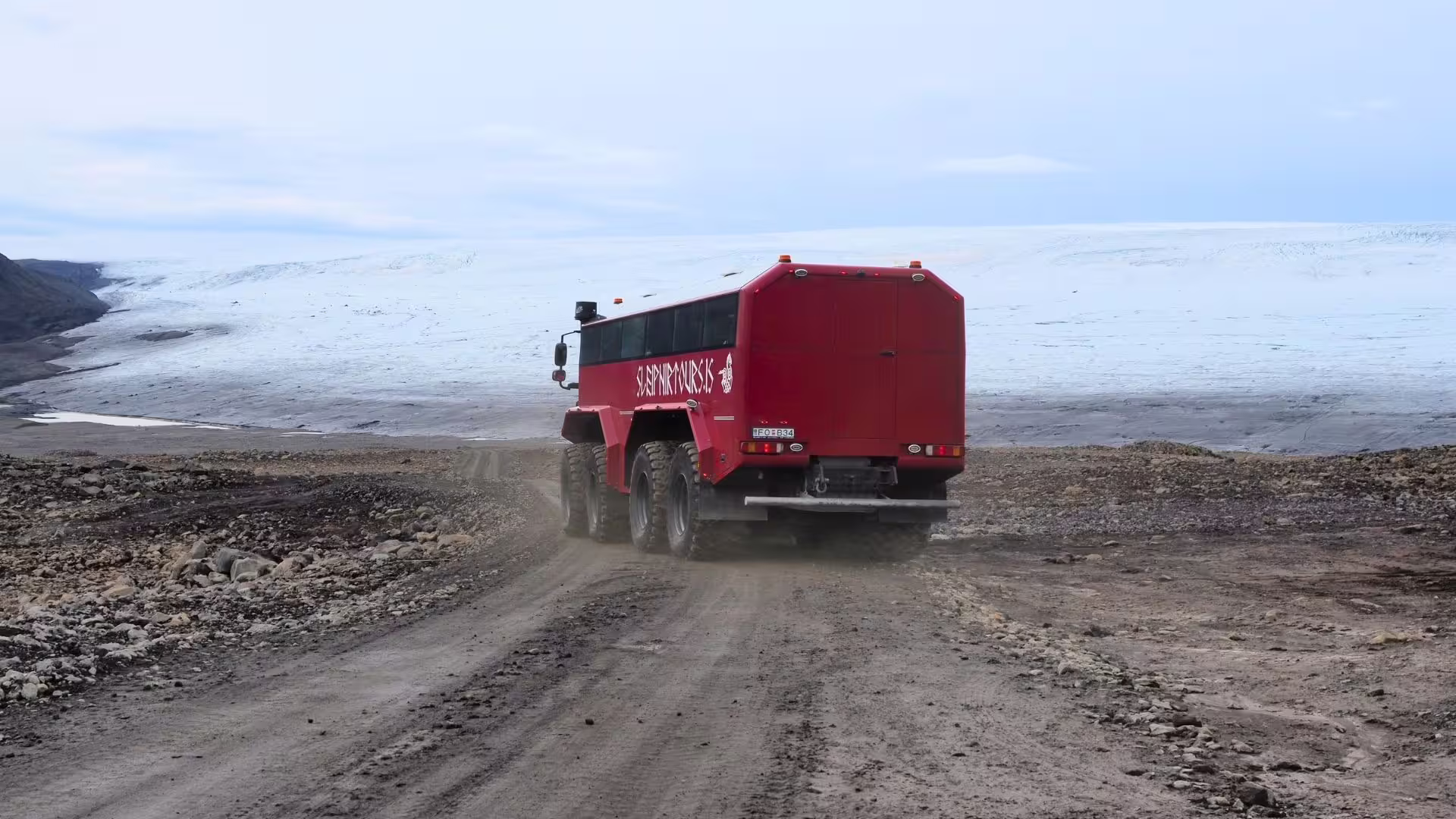 Red glacier bus heading to Langjökull on the Summer Solstice tour from Gullfoss across Icelandic highlands