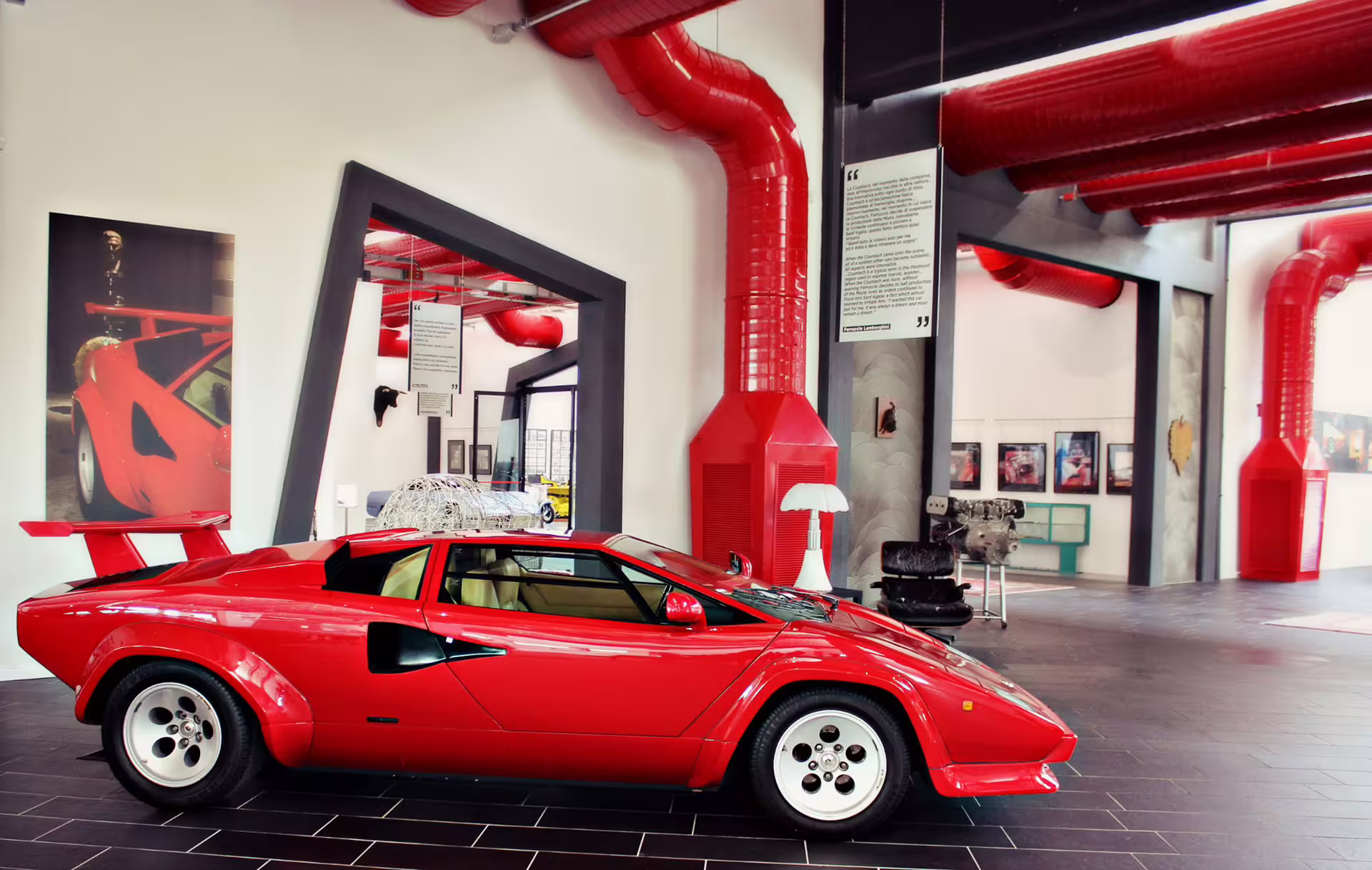 Side view of red Lamborghini Countach at Ferruccio Lamborghini Museum near Bologna with entry ticket