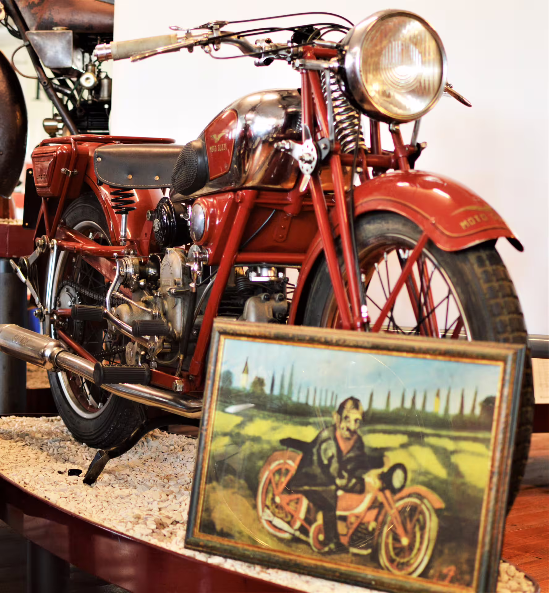 Close-up of red vintage Moto Guzzi on display at Rimini National Motorcycle Museum tour