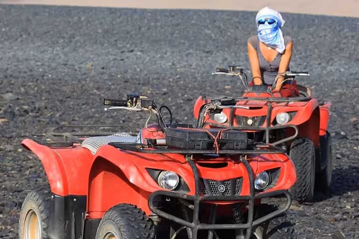 Red quad bikes on a Sharm El Sheikh desert safari, ATV adventure ride across rocky Sinai terrain