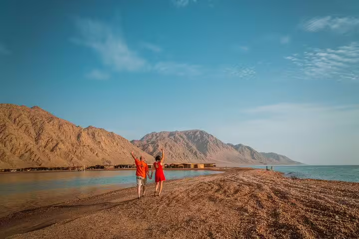 Travelers walking by the Red Sea in Sinai, scenic stop on private overnight Saint Catherine Monastery and Mount Sinai tour
