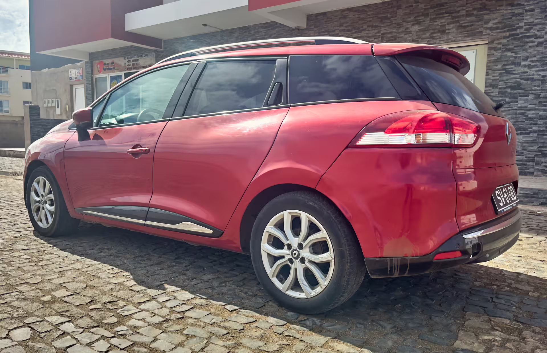 Red SUV parked outside transfer office, ideal for private airport transfer and city hotel pickup service
