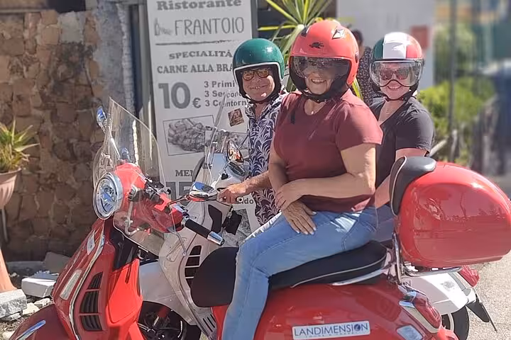 Tourists on red Vespas ready to explore Rome, highlighting the excitement of a private guided Vespa tour.