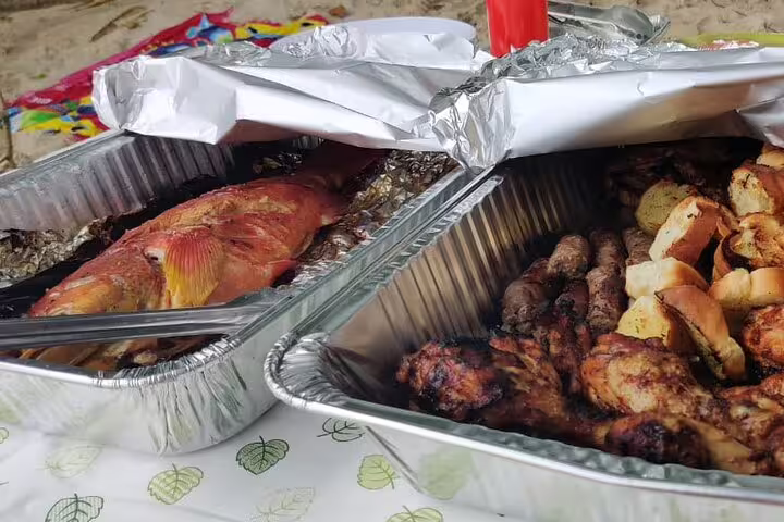 Delicious grilled seafood and meats served on the beach during the Reef Safari private day trip with lunch.