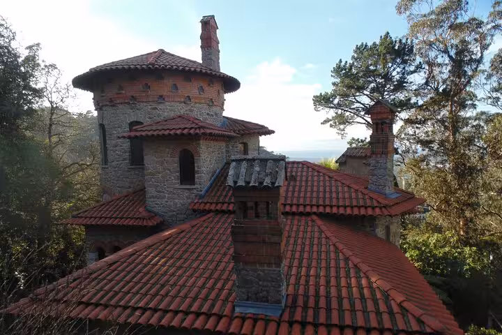 Charming stone building with red-tiled roofs nestled in the greenery of Sintra's mystical landscape.