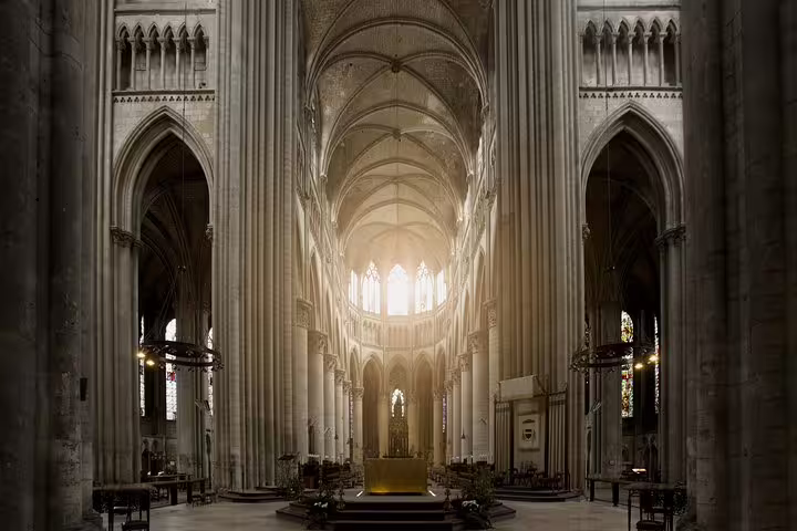Gothic interior of Reims Cathedral illuminated by soft light, a highlight on a private Champagne day trip with French lunch from Paris.