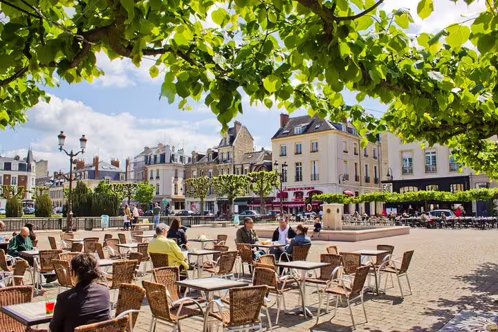 Sunny café terrace in central Reims, ideal stop on an e-scavenger hunt as you explore the city at your pace