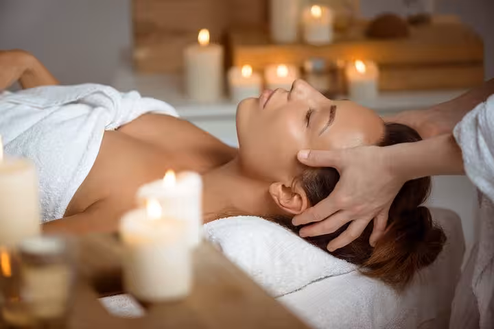 Relaxing head massage in Luxor hammam spa with candles, part of 2-hour Turkish bath and massage package