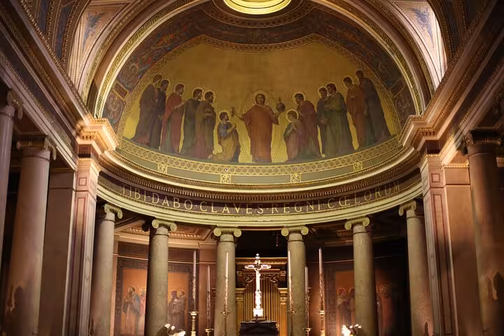 Intricate domed ceiling of a cathedral in Rennes, featuring biblical figures and Latin inscriptions during the city tour.