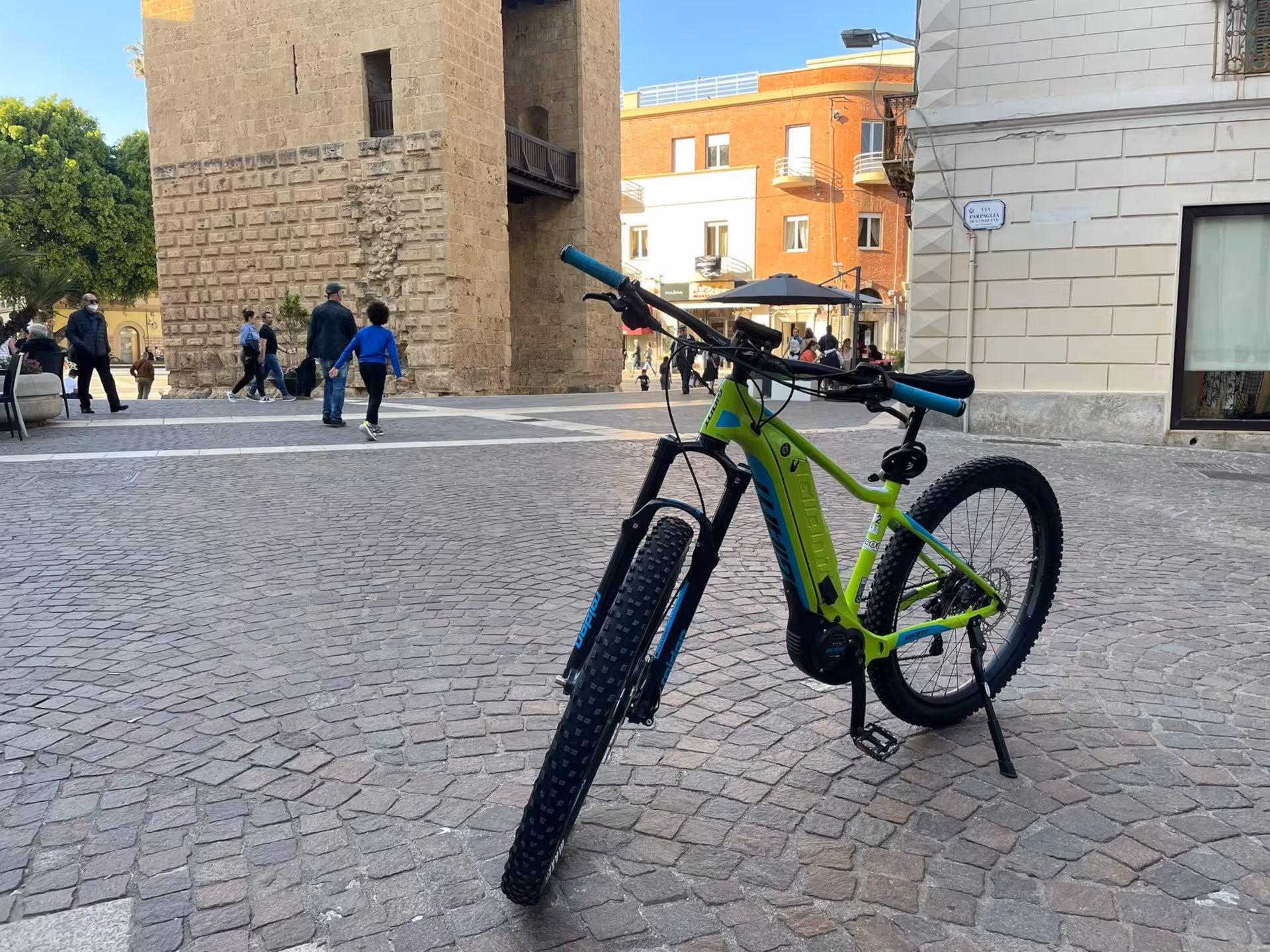 Discover Oristano's vibrant atmosphere with a rented e-bike, ideal for exploring Sardinia's historic sites.