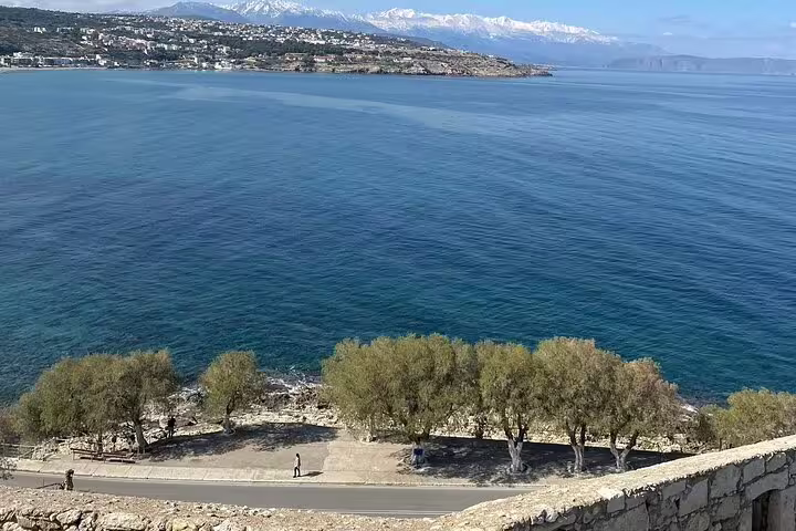 Breathtaking view of the azure sea and distant snowy mountains from Rethymno, perfect for a private tour experience.