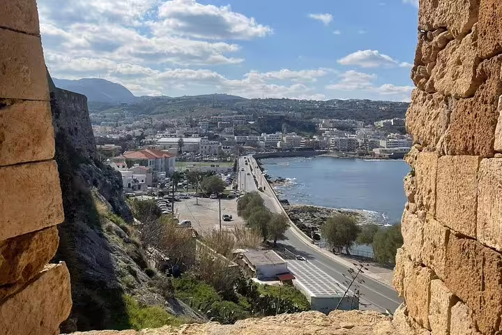 Panoramic view of Rethymno Town and coastline from a historic site, featured in a private tour from Chania.