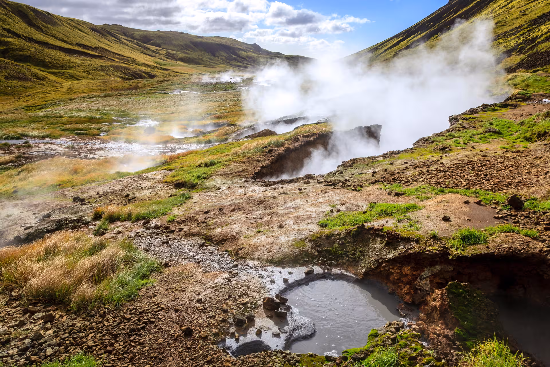 Steaming geothermal vents in Reykjadalur valley on a private hike near Hveragerdi, South Iceland
