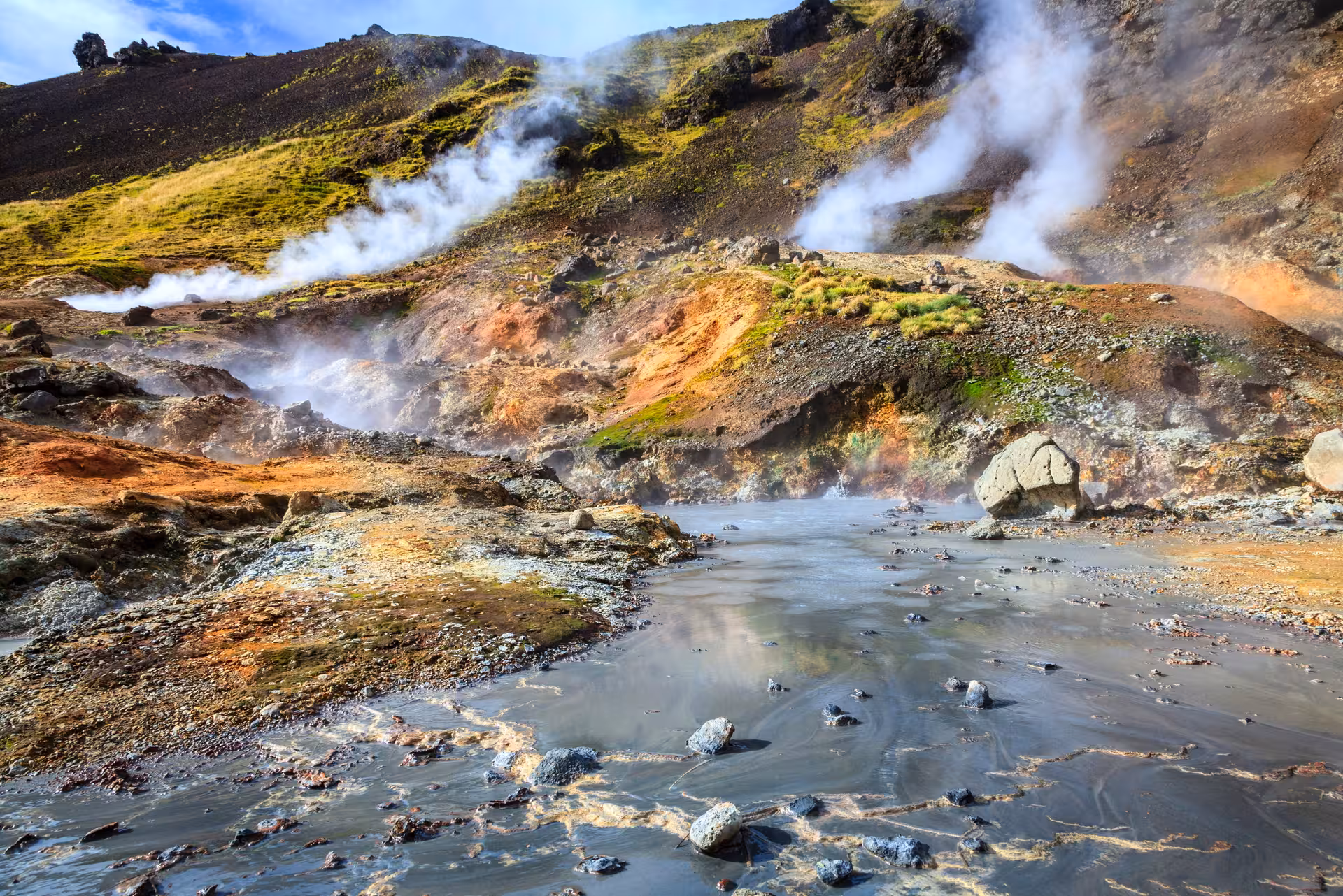 Steaming fumaroles and muddy geothermal pools in Grændalur on Private Reykjadalur & Grændalur circle hike