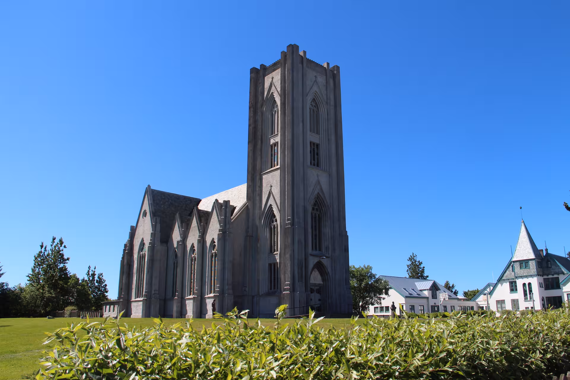 Explore the stunning architecture of Reykjavík Cathedral under a clear blue sky on a private city tour.