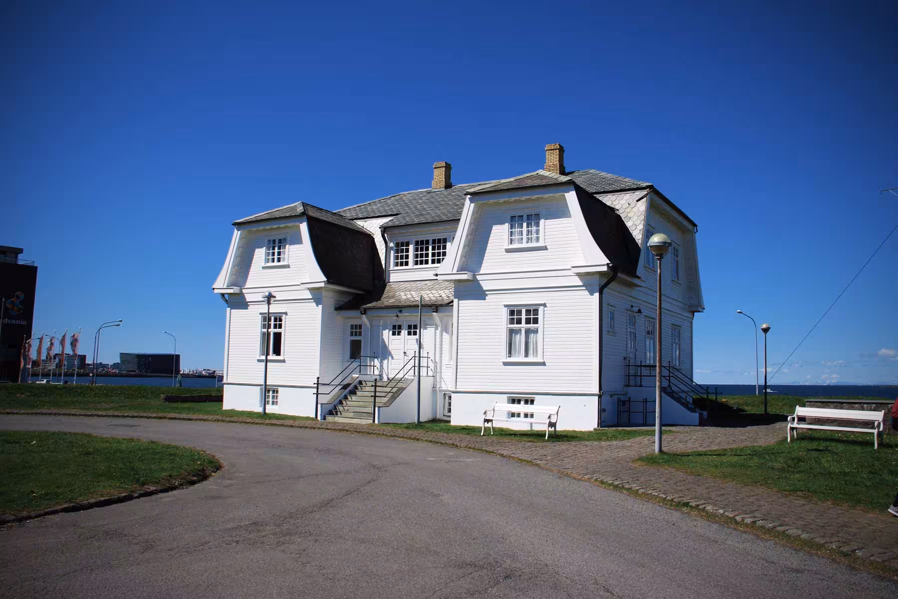 Historic white house under clear blue sky in Reykjavik, perfect stop on a private city tour.