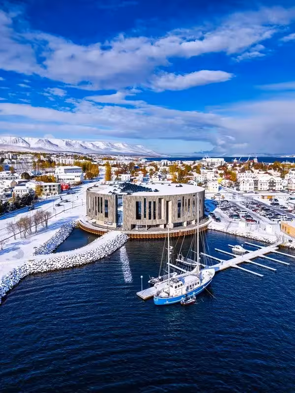 Reykjavik winter harbor view with Harpa Concert Hall, snowy skyline, on Iceland Christmas adventure tour