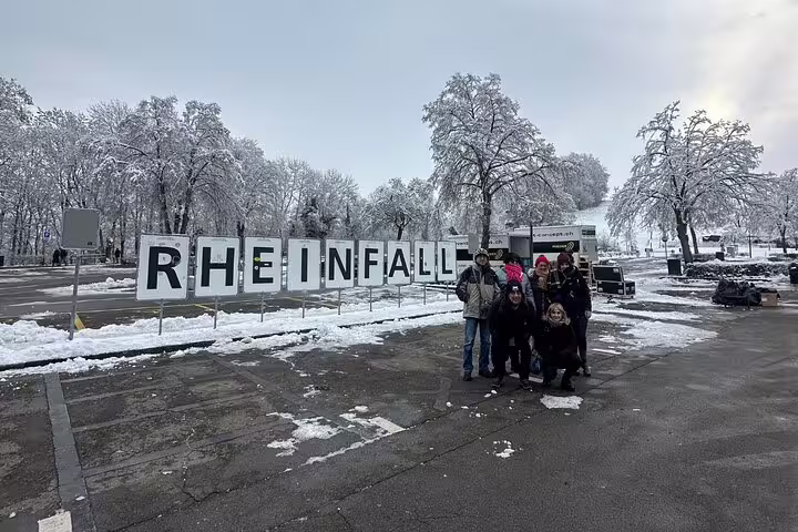 Group of tourists at snowy Rhine Falls entrance, perfect for Zurich Rhine Falls & Stein am Rhein day trip.