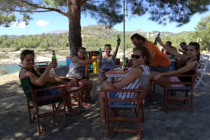 Friends relaxing at a lakeside taverna during a private car Limni day trip from Rhodes, Greece