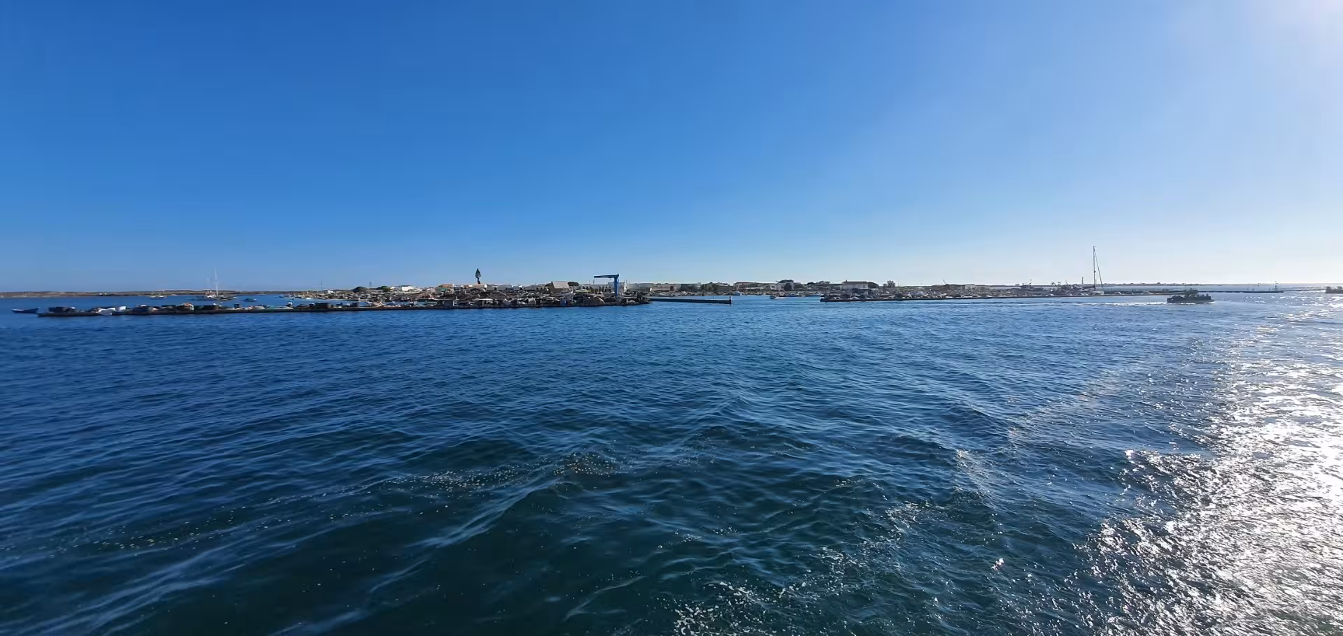 Panoramic view of Ria Formosa lagoon with clear blue skies on a private boat tour.