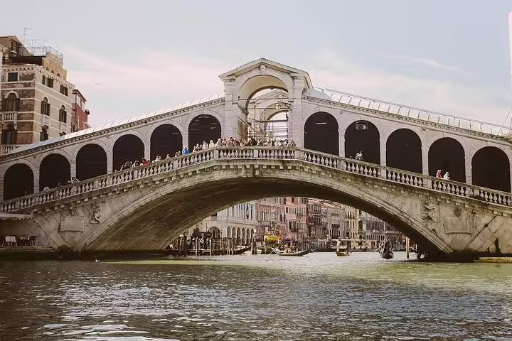 Iconic Rialto Bridge arching over the Grand Canal, perfect sightseeing on a Murano and Burano private boat tour.