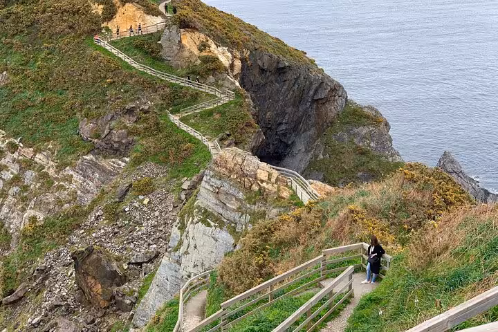 Scenic path along cliffs at Fuciño do Porco, offering stunning ocean views and a popular hiking spot near Santiago.