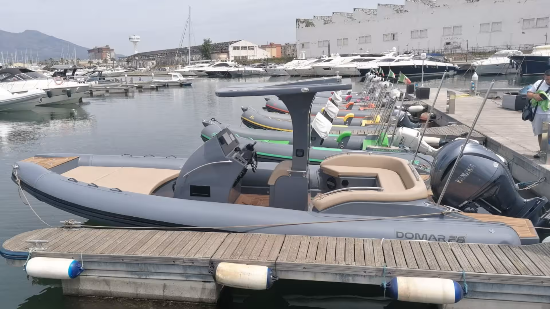 RIB boat docked at Arbatax marina ready for Cala Luna and Cala Goloritzé tour, featuring sleek design and modern amenities.