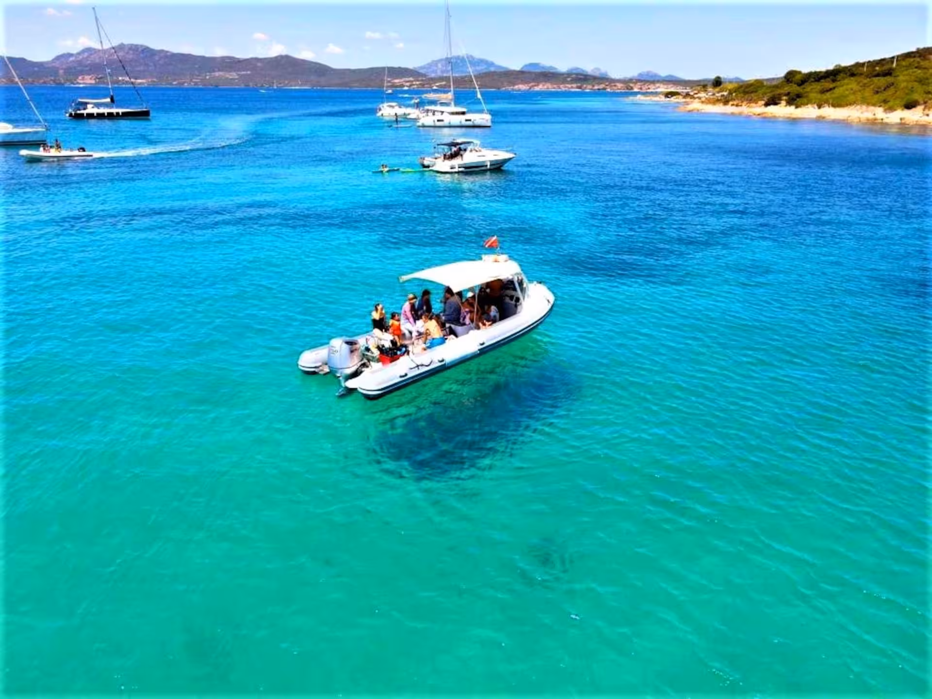 Scenic RIB boat excursion on turquoise waters near Capo Figari, ideal for dolphin watching trips from Olbia.